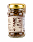 A glass jar of Mitla Gran Sal de Gusano (Agave Worm Salt) with a gold metal lid and a beige label, shown on a solid white background.