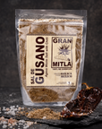 Gran Mitla Sal de Gusano 1kg bag with dried chili peppers and sea salt on dark slate — bold spicy worm salt from Oaxaca
