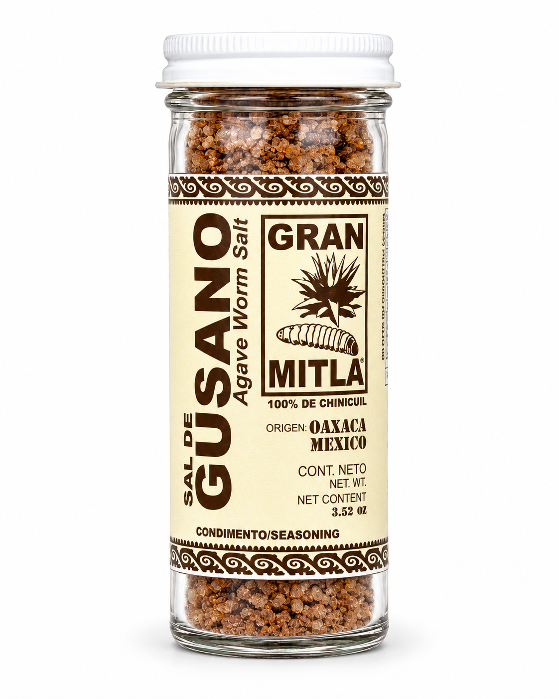 A glass jar of Gran Mitla Sal de Gusano (Agave Worm Salt) on a solid white background. The jar contains brown segmented salt, with a cream-colored label featuring brown text and borders, and a white screw cap.